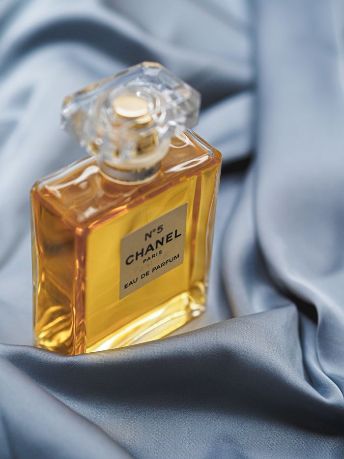 trusted-partner Chanel No. 5 perfume bottle resting on luxurious silk fabric, capturing elegance in Paris.
