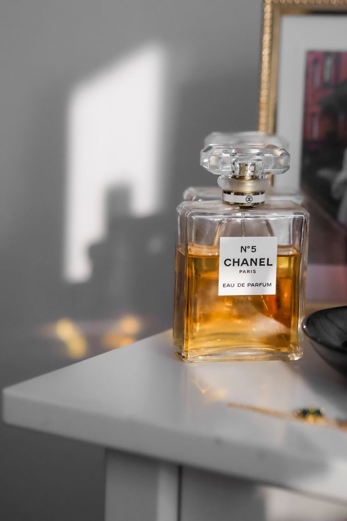journey-01 Luxury Chanel No. 5 perfume bottle elegantly displayed on a white shelf.