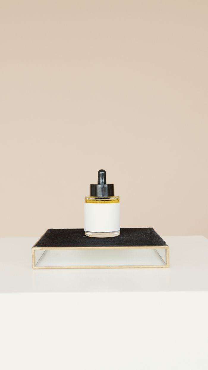 services-01 Elegant skincare product on a black stand against a neutral background.